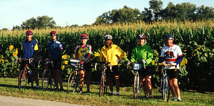 Group of six in front of field.