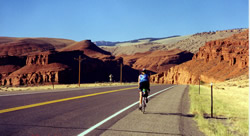 Biker with red rock formation.